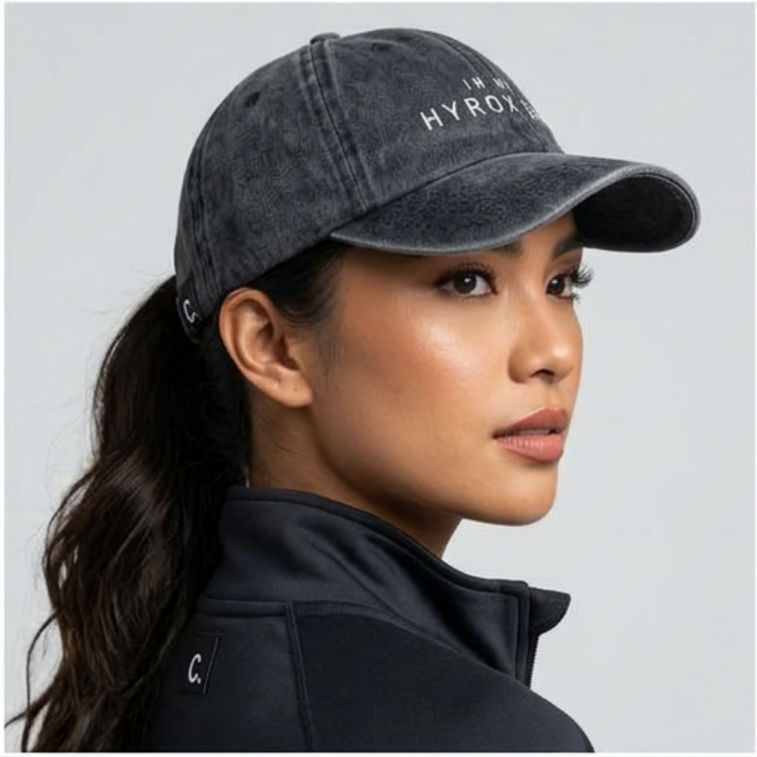 Model wearing black washed IN MY HYROX ERA cap for training and everyday movement