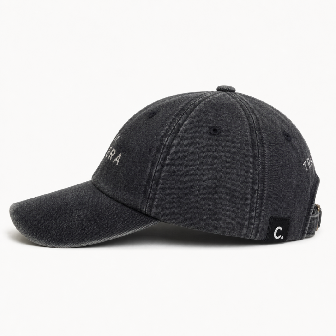 Close-up of black washed cap fabric and off-white embroidery detail