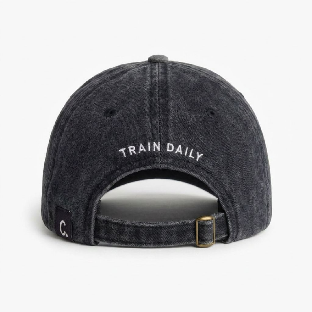 Back view of black washed cap with TRAIN DAILY curved embroidery