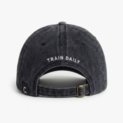 Back view of black washed cap with TRAIN DAILY curved embroidery