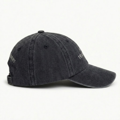 Close-up of black washed cap fabric and off-white embroidery detail